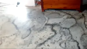 Cracked and uneven basement floor in need of repair. Click here to learn how to finish your basement floor!