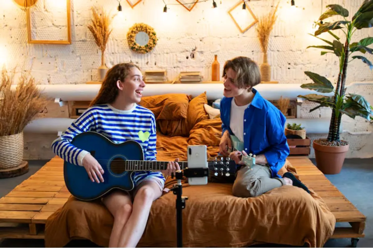 teenage boy and girl recording music on basement living space